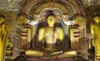 Rock Temple of Dambulla, Buddha shrine, large colourful statue, intricate carvings