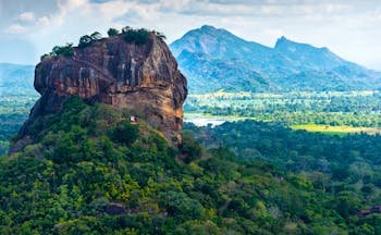 Sigiriya rock, sprawling landscape, mountains in background