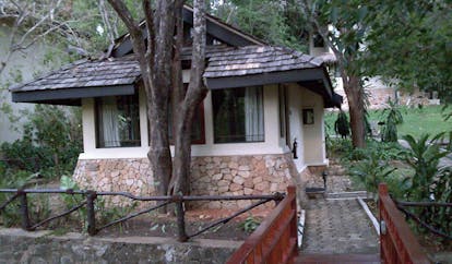Deer Park Sri Lanka cottage bridge entrance wooden bridge to white and stone cottage