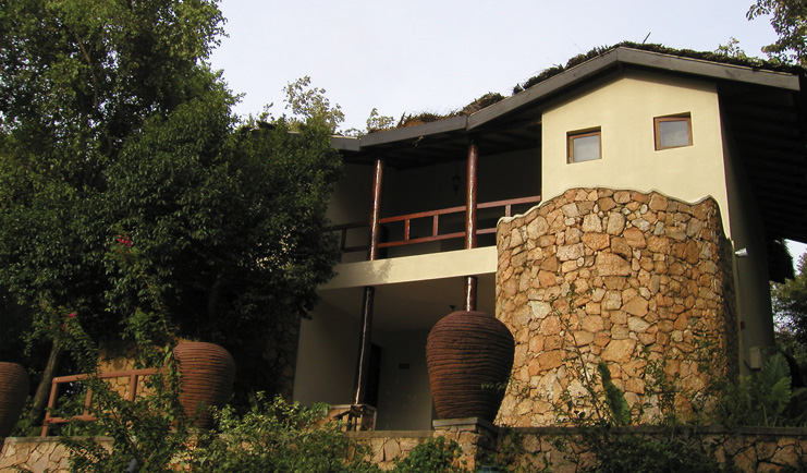 Deer Park Sri Lanka cottage exterior building stonework balconies trees urns