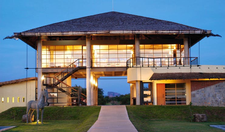 The Elephant Corridor Sri Lanka hotel exterior building with large glass windows and horse statue