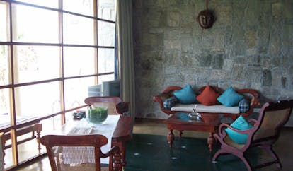 The Elephant Corridor Sri Lanka rustic lounge stone walls sofa and chairs