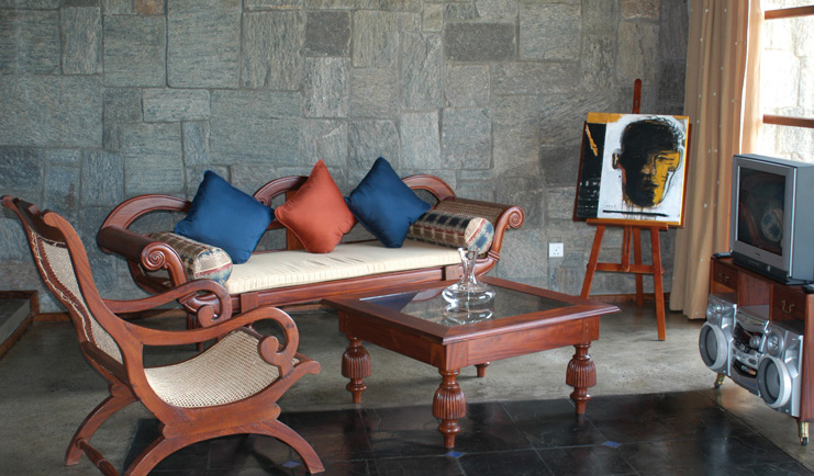 The Elephant Corridor Sri Lanka suite lounge wooden sofa and chair easel with picture and television