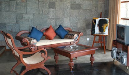 The Elephant Corridor Sri Lanka suite lounge wooden sofa and chair easel with picture and television