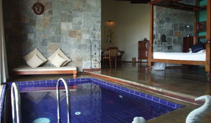 The Elephant Corridor Sri Lanka suite pool four poster bed sofa indoor pool