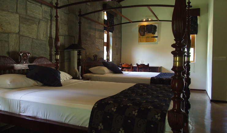 The Elephant Corridor Sri Lanka twin four poster bedroom stone walls desks