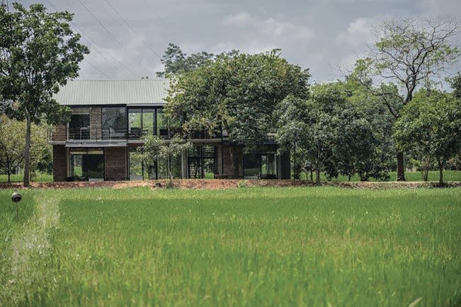 Kalundewa Retreat damunu chaler exterior, modern architecture, large lass windows, building surrounded by grass and trees