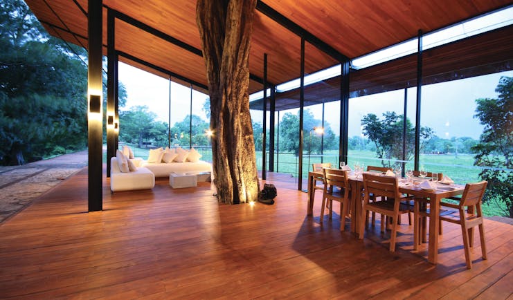 Kalundewa Retreat lobby, covered terrace with tree growing in centre, sofa, tables, views of surrounding countryside