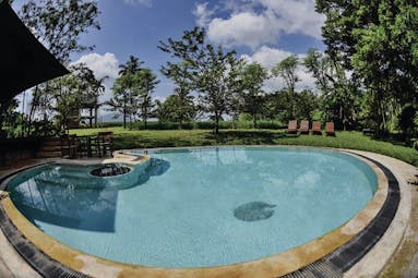Kalundewa Retreat pool, surrounded by lawns, sun loungers