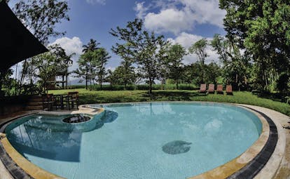 Kalundewa Retreat pool, surrounded by lawns, sun loungers