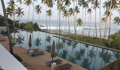 Amanwella Sri Lanka swimming pool loungers umbrellas beach view
