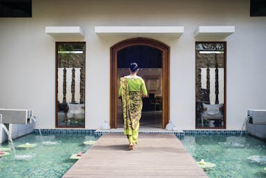 Anantara Peace Haven Tangalle Sri Lanka spa entrance walkway over water feature woman