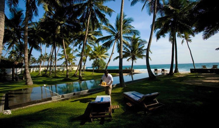 Apa Villa Thalpe Sri Lanka infinity pool with loungers and sea view