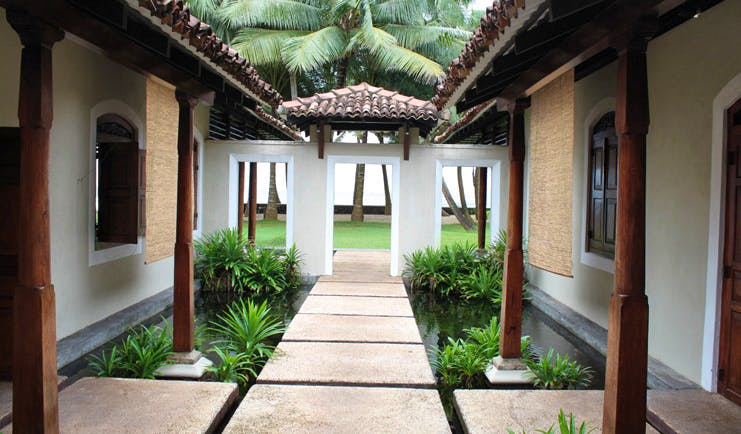 Apa Villa Thalpe Sri Lanka walkway with white and brown buildings