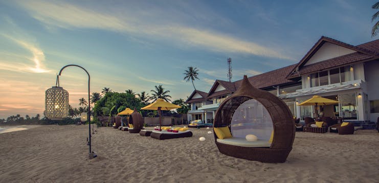 Casa Colombo Mirissa Sri Lanka beach sun beds sun loungers sand hotel in background