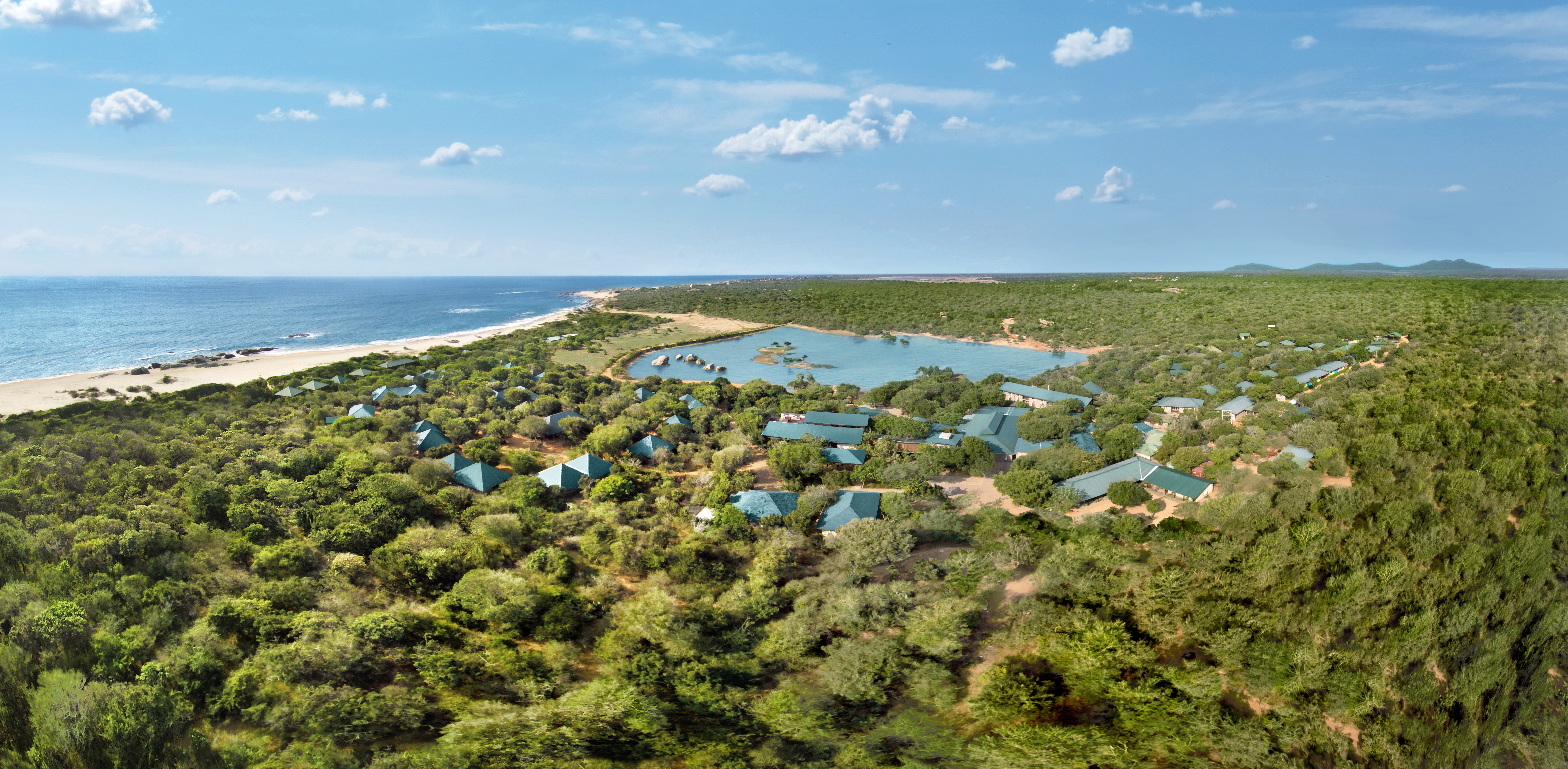 Cinnamon Wild aerial shot of resort, buildings nestled amongst tropical greenery, hotel buildings, beach and sea in background