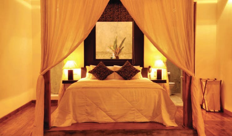 Era Beach Hotel guestroom, canopied bed, bright modern decor