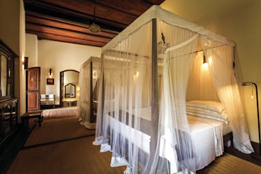 Galle Fort Hotel library suite, canopied bed, elegant minimal decor