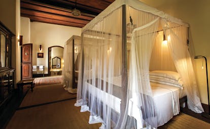 Galle Fort Hotel library suite, canopied bed, elegant minimal decor
