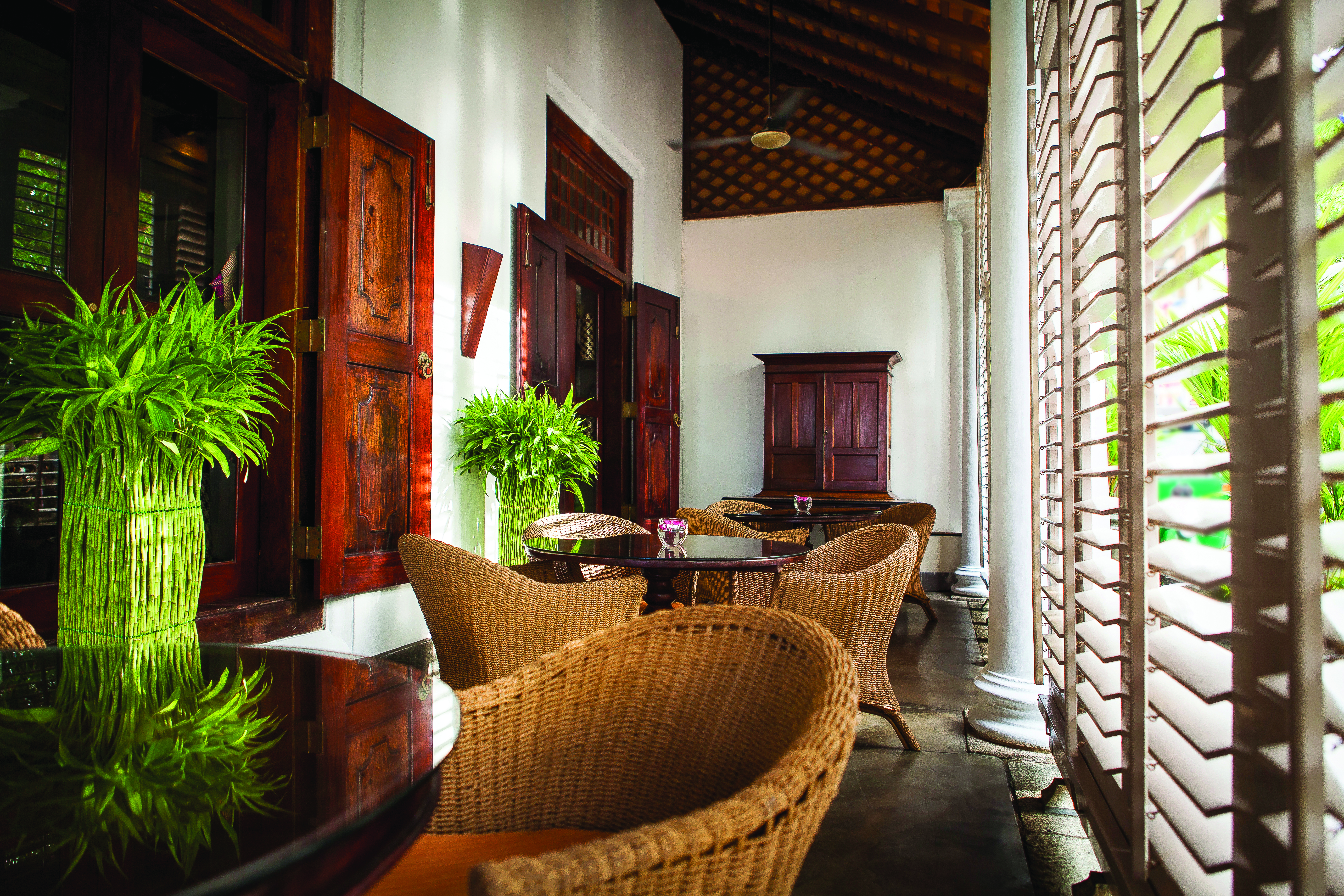Galle Fort Hotel verandah, indoor sitting area, wicker tables and chairs, colonial style decor