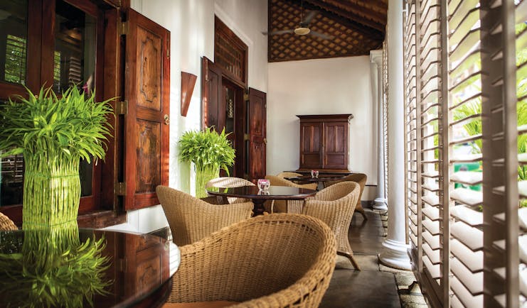 Galle Fort Hotel verandah, indoor sitting area, wicker tables and chairs, colonial style decor