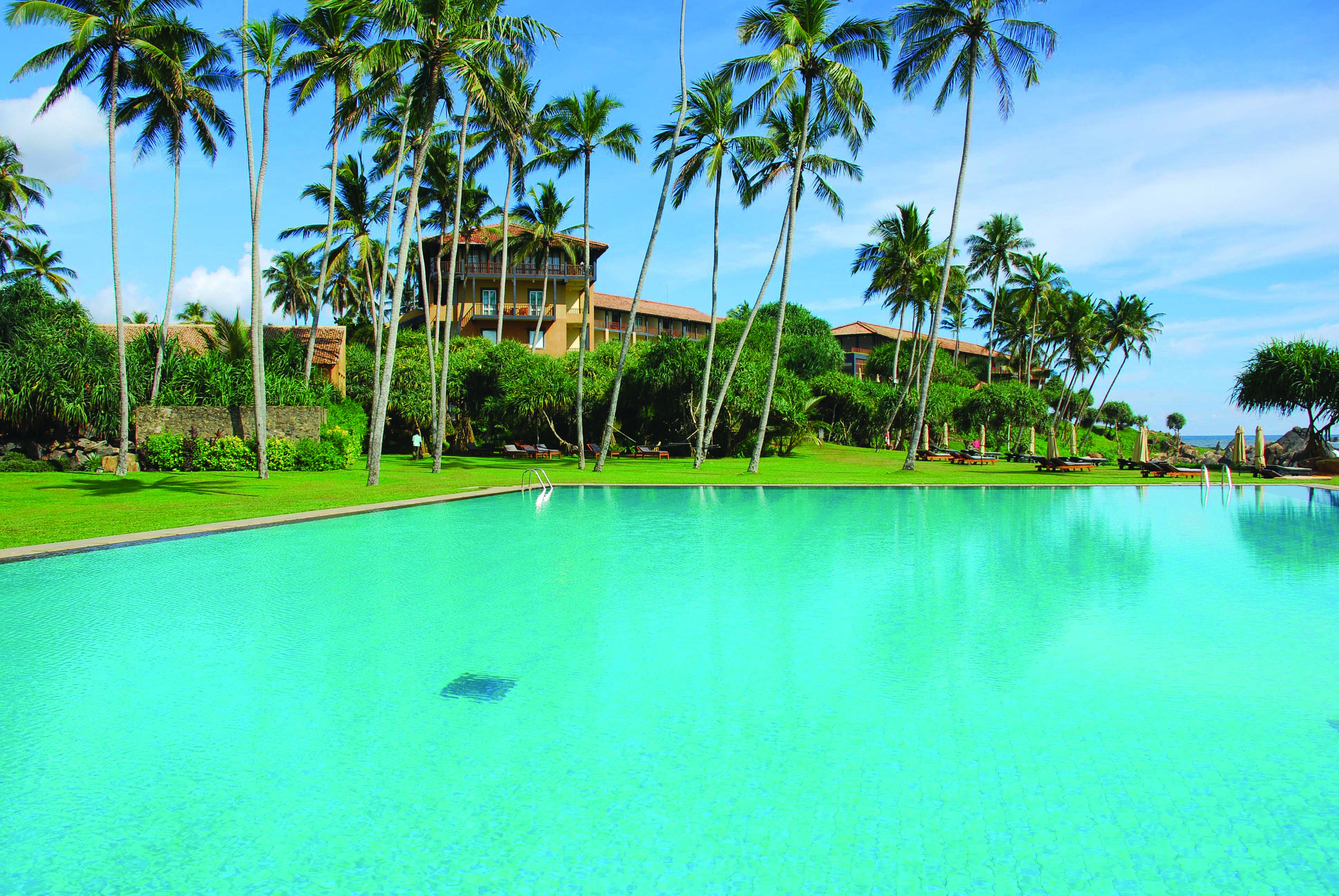 Jetwing Lighthouse Sri Lanka outdoor pool garden hotel view palm trees