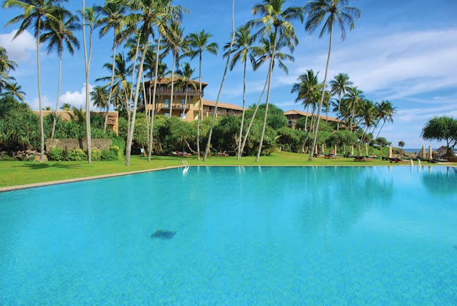 Jetwing Lighthouse Sri Lanka outdoor pool garden hotel view palm trees