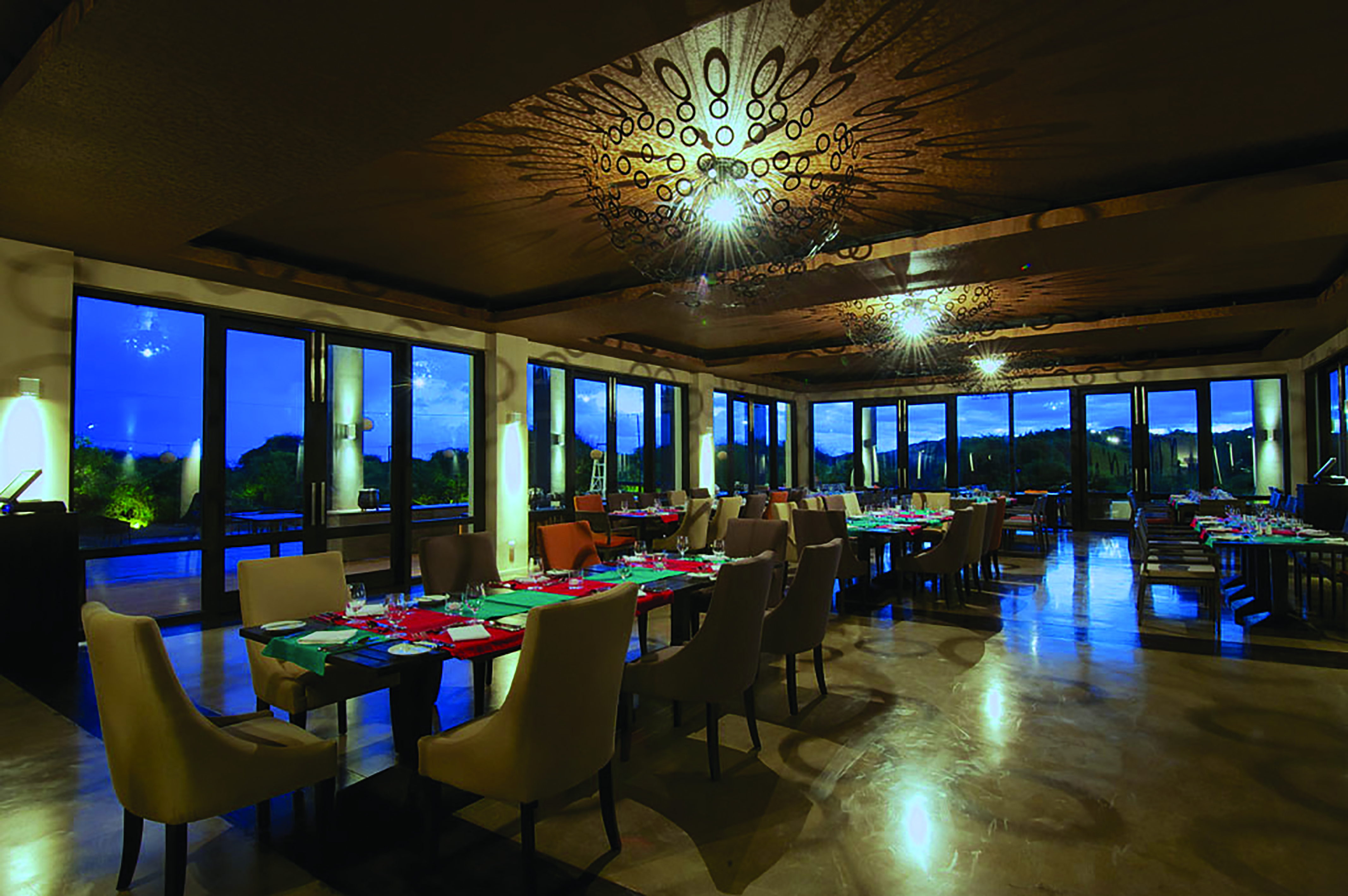 Jetwing Yala restaurant, tables and chairs, modern decor, large windows offering rural views