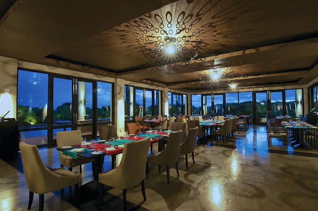 Jetwing Yala restaurant, tables and chairs, modern decor, large windows offering rural views