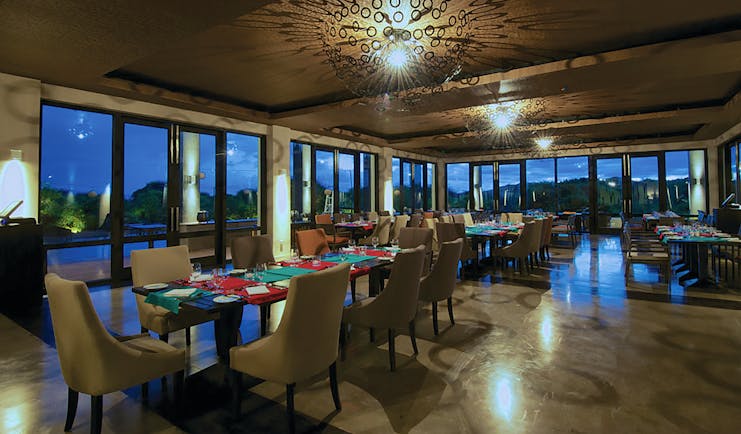 Jetwing Yala restaurant, tables and chairs, modern decor, large windows offering rural views