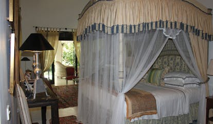Kahanda Kanda Sri Lanka garden suite bedroom with four poster bed drapes and patio 