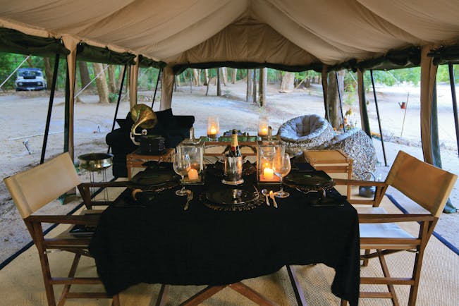 Leopard Trails dining tent, table set for dinner with champagne