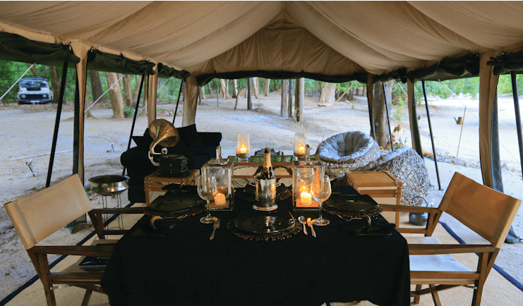 Leopard Trails dining tent, table set for dinner with champagne
