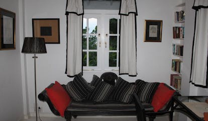 The Sun House Sri Lanka Dumas suite lounge with sofa and window 