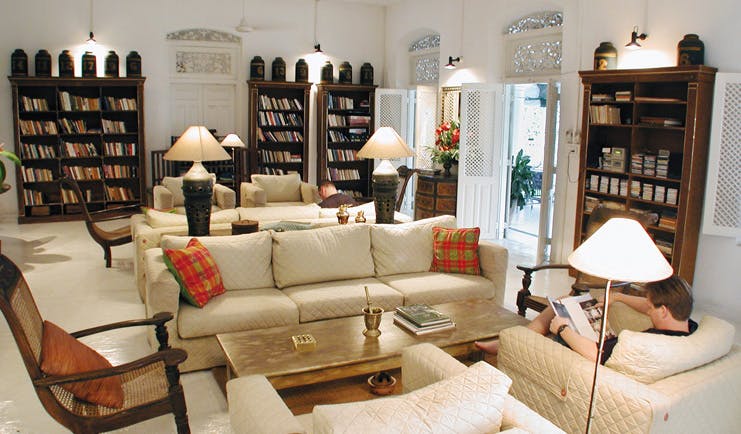 The Sun House Sri Lanka library lounge with bookshelves and sofas