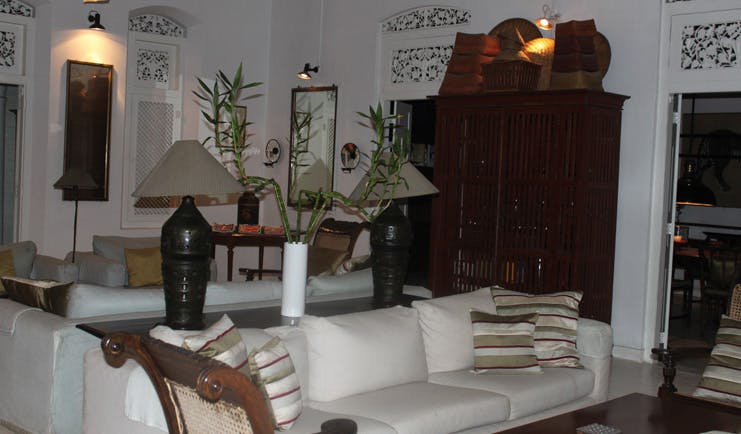 The Sun House Sri Lanka sitting room with sofas and white carved vents