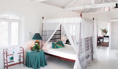 The Sun House Sri Lanka white bedroom exposed beams four poster bed white drapes