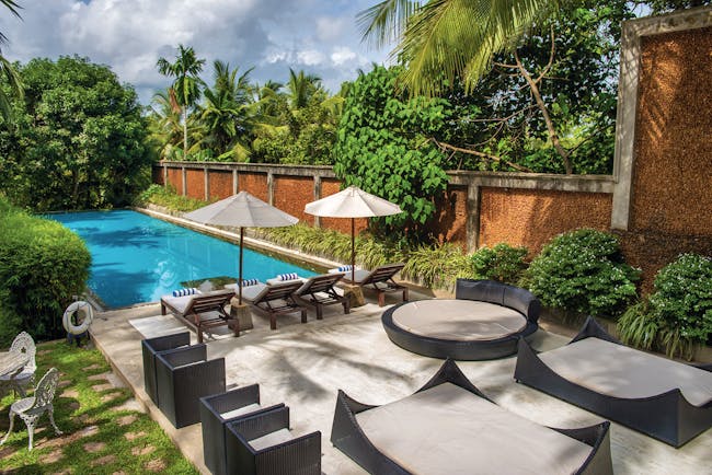 Tamarind Hill Sri Lanka pool sun loungers umbrellas patio greenery