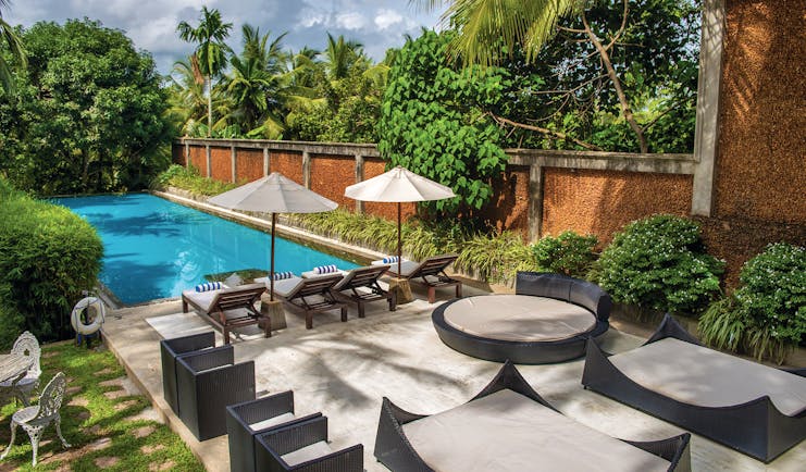 Tamarind Hill Sri Lanka pool sun loungers umbrellas patio greenery