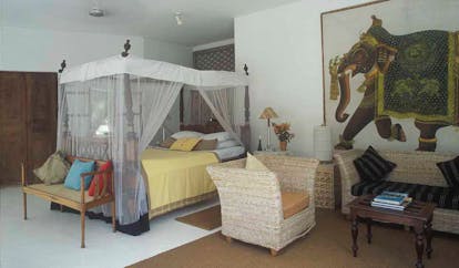 Taprobane Island Sri Lanka bedroom four poster bed sitting area large traditional elephant painting