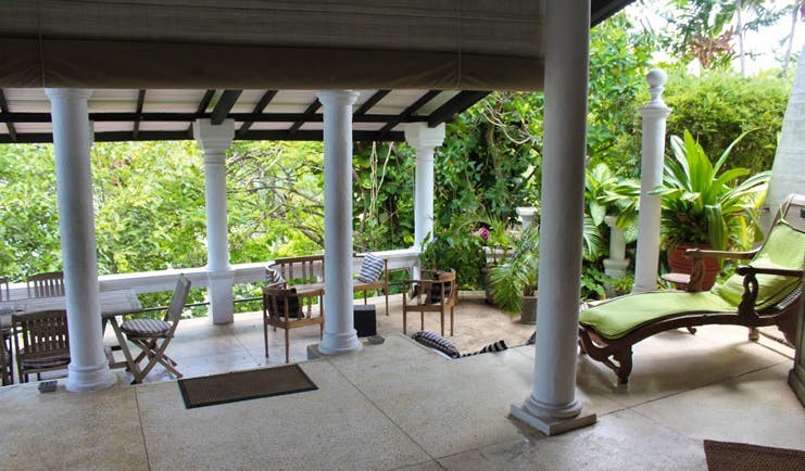 Taprobane Island Sri Lanka patio seating area columns loungers and tropical plants