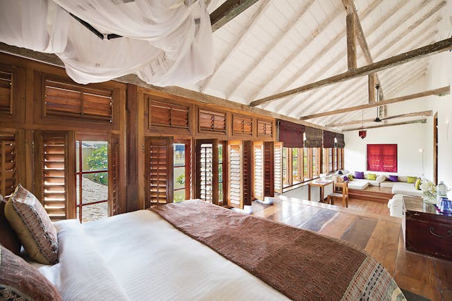 The Fort Printers headmaster suite, bed, lounge area, shuttered windows, cosy decor
