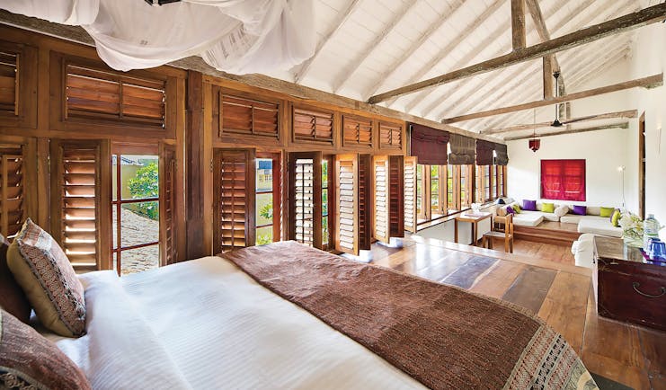 The Fort Printers headmaster suite, bed, lounge area, shuttered windows, cosy decor