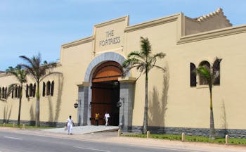 Exterior with palm trees outside and cream coloured building