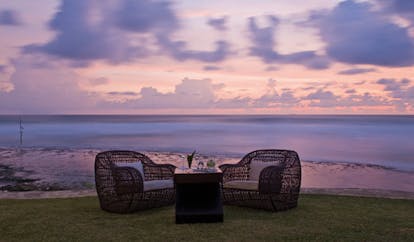 The Fortress Sri Lanka outdoor seating wicker armchairs in gardens beach view sunset