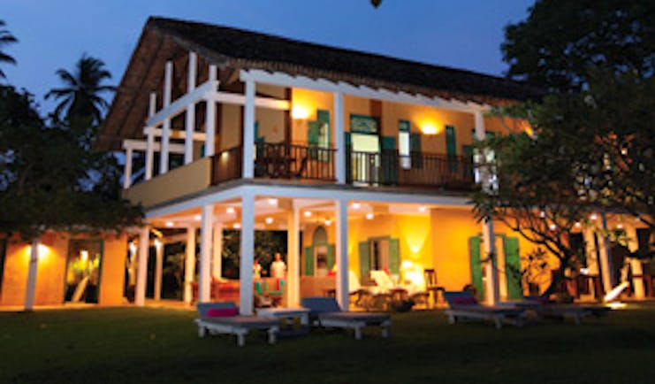 The Last House exterior at night with lamps and lights glowing