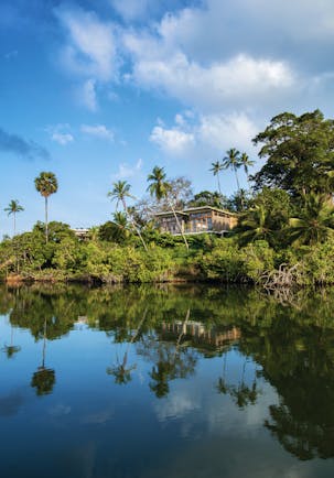 Tri Lanka Sri Lanka hotel building overlooking lake surrounded by trees and nature