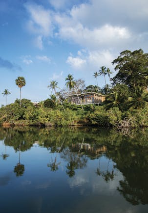 Tri Lanka Sri Lanka hotel building overlooking lake surrounded by trees and nature
