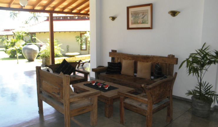 Weligama Bay Resort Sri Lanka lobby wooden seats and table view of gardens