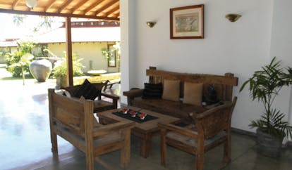 Weligama Bay Resort Sri Lanka lobby wooden seats and table view of gardens